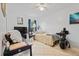 Simple bedroom featuring neutral-colored tile, comfortable bed, and basic furniture arrangement at 971 Cascades Park Trl, Deland, FL 32720