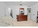 Bedroom featuring light neutral tile, closet and bathroom access, and a wooden dresser at 971 Cascades Park Trl, Deland, FL 32720