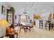 Open dining room featuring an elegant wood table, china cabinet, and bar seating overlooking the kitchen at 971 Cascades Park Trl, Deland, FL 32720