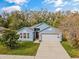 Beautiful one-story home with a light blue facade, two car garage, and well maintained lawn at 971 Cascades Park Trl, Deland, FL 32720