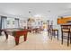 Open-concept recreation room with a pool table, dining table, and bar seating at 971 Cascades Park Trl, Deland, FL 32720