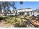 Exterior view of the home with a spacious backyard, landscaping and fenced yard at 1318 Pup Fish Ln, Deland, FL 32724