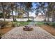 Backyard featuring a brick fire pit with a seating bench at 1318 Pup Fish Ln, Deland, FL 32724