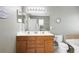 Bathroom with double sinks, a large mirror, and a toilet, offering functionality and ample space at 1318 Pup Fish Ln, Deland, FL 32724