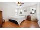 Cozy bedroom with hardwood floors, a ceiling fan, and natural light, creating a comfortable and relaxing atmosphere at 1318 Pup Fish Ln, Deland, FL 32724