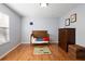 Charming bedroom with hardwood floors, dresser, and decor at 1318 Pup Fish Ln, Deland, FL 32724