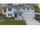 Charming two-story home featuring a well-manicured lawn and attached two-car garage, enhancing curb appeal at 1318 Pup Fish Ln, Deland, FL 32724