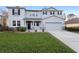 Charming two-story home featuring a manicured lawn and welcoming front entrance at 1318 Pup Fish Ln, Deland, FL 32724