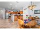Kitchen and breakfast nook featuring tile floors, stainless appliances, and wooden cabinetry at 1318 Pup Fish Ln, Deland, FL 32724