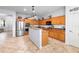 Bright kitchen features stainless steel appliances, tile flooring, and wooden cabinetry at 1318 Pup Fish Ln, Deland, FL 32724