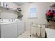 Functional laundry room with modern washer and dryer units and storage space at 1318 Pup Fish Ln, Deland, FL 32724