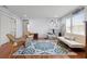 Spacious living room featuring wood floors, an exercise area, a comfortable sofa, and a decorative rug at 1318 Pup Fish Ln, Deland, FL 32724