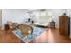 Bright, sunny living room with an exercise area, hardwood floors, and a cozy seating area near the windows at 1318 Pup Fish Ln, Deland, FL 32724