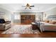 Bright bedroom with hardwood floors, a tray ceiling, a cozy seating area, and an area rug at 1318 Pup Fish Ln, Deland, FL 32724