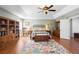 Inviting bedroom with tray ceilings, wood floors, an area rug, and ample storage with shelving and dressers at 1318 Pup Fish Ln, Deland, FL 32724