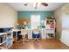 Bright office space featuring hardwood floors, dual workstations, and ample storage for an organized work environment at 1318 Pup Fish Ln, Deland, FL 32724