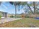 Large, fenced backyard featuring a brick patio and a variety of mature trees and foliage at 141 N Mcdonald Ave, Deland, FL 32724