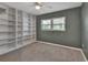 Bedroom features a built in bookshelf, ceiling fan and carpet flooring at 141 N Mcdonald Ave, Deland, FL 32724