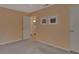 Bedroom showcasing neutral carpet, ceiling fan, and view of the en-suite bathroom at 141 N Mcdonald Ave, Deland, FL 32724
