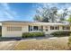 Inviting single-story home with manicured landscaping and a classic design at 141 N Mcdonald Ave, Deland, FL 32724