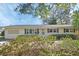 Charming home with a well-maintained front yard and colorful flowering bushes at 141 N Mcdonald Ave, Deland, FL 32724