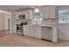 Modern kitchen with stainless steel appliances, white cabinets, and a tile backsplash at 141 N Mcdonald Ave, Deland, FL 32724