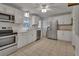 Well-equipped kitchen with stainless steel appliances and white cabinets at 141 N Mcdonald Ave, Deland, FL 32724