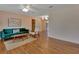 Hardwood floor living room featuring a ceiling fan and an exit to a backyard at 141 N Mcdonald Ave, Deland, FL 32724