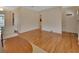 Open-concept living area with hardwood floors leading to the front door and other rooms at 141 N Mcdonald Ave, Deland, FL 32724