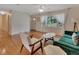 Bright living room with hardwood floors, a ceiling fan, and a large window with sheer curtains at 141 N Mcdonald Ave, Deland, FL 32724