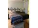 Bedroom with two beds, wood floors, and a view of the en suite bathroom at 1420 Felton St, Deltona, FL 32725