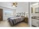 Bedroom featuring two twin beds, ceiling fan, and adjacent bathroom at 1420 Felton St, Deltona, FL 32725