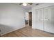 Bright bedroom features wood floors, a ceiling fan, neutral paint and closet at 1420 Felton St, Deltona, FL 32725