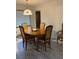 Cozy dining room featuring wooden table, floral cushioned chairs, and decorative overhead lighting at 1420 Felton St, Deltona, FL 32725