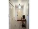 Bright hallway with neutral walls, hardwood floors, closet, and decorative lighting fixture at 1420 Felton St, Deltona, FL 32725