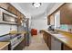 Well-lit kitchen featuring stainless steel appliances, wood cabinets, and an open view to living space at 1420 Felton St, Deltona, FL 32725