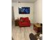 Comfortable living room featuring wood-look flooring, a TV, and seating, creating a cozy space at 1420 Felton St, Deltona, FL 32725