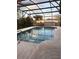 Screened-in pool featuring concrete deck and a view of the backyard at 1420 Felton St, Deltona, FL 32725