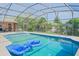 Relaxing screened-in pool area with clear blue water and lounge floats, perfect for outdoor enjoyment at 1420 Felton St, Deltona, FL 32725