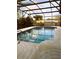 Relaxing screened-in pool with clear blue water and patio at 1420 Felton St, Deltona, FL 32725