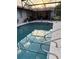 Backyard pool enclosed with a screen; perfect for outdoor relaxation and recreation at 1420 Felton St, Deltona, FL 32725