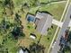 Aerial view of the property showcasing the screened pool, fenced yard, and lush landscaping at 1489 Casey Ln, Port Orange, FL 32129