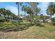 The backyard is spacious, sunny, with mature trees and lush lawn at 1489 Casey Ln, Port Orange, FL 32129