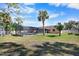 Backyard view of property featuring screen enclosed pool and abundant shade trees at 1489 Casey Ln, Port Orange, FL 32129