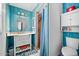Blue-themed bathroom with a shower, vanity, and toilet, with a blue wood accent wall at 1489 Casey Ln, Port Orange, FL 32129