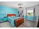 Charming bedroom with colorful decor, a comfortable bed, and a window providing natural light at 1489 Casey Ln, Port Orange, FL 32129