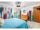 Bright bedroom featuring stylish curtains, light walls, wood floors, and ample closet space at 1489 Casey Ln, Port Orange, FL 32129