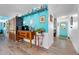 Open kitchen view featuring blue cabinets, open shelves, stainless-steel appliances, and stylish decor at 1489 Casey Ln, Port Orange, FL 32129