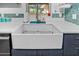 Close-up of the kitchen's farmhouse sink, complete with modern fixtures and stylish backsplash at 1489 Casey Ln, Port Orange, FL 32129