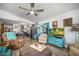 Cozy living room with comfortable seating, ceiling fan, and open view to the modern kitchen at 1489 Casey Ln, Port Orange, FL 32129